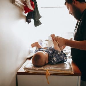 dad changing baby's diaper